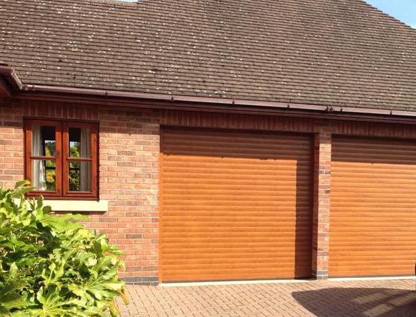 Two Aluroll Classic made to measure insulated roller doors in Golden Oak